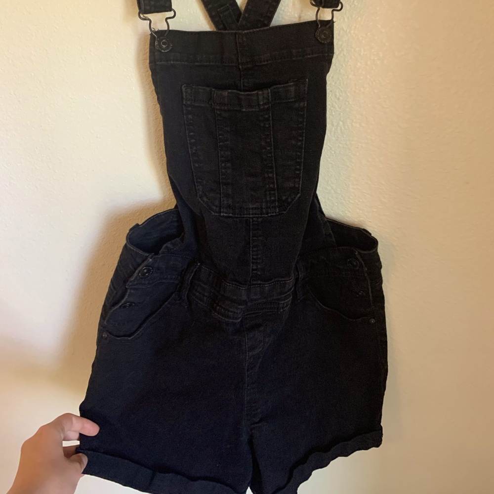 Cute black short overalls crossed in the back.